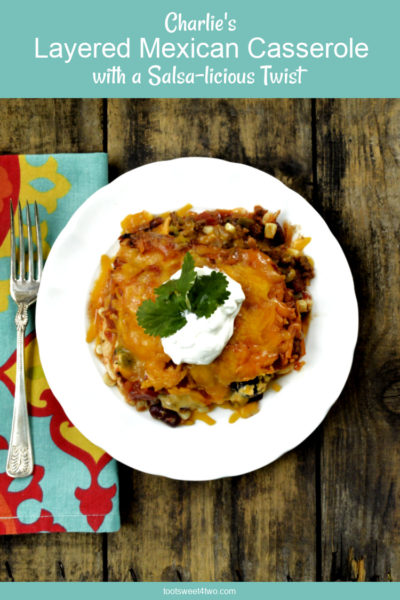 Layered Mexican Casserole on a white plate - overhead flatlay