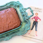 chocolate cake in a 9x13 pan on a turquoise serving tray