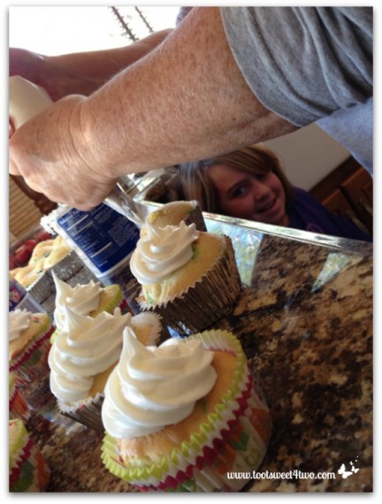 Patti piping frosting on cupcakes