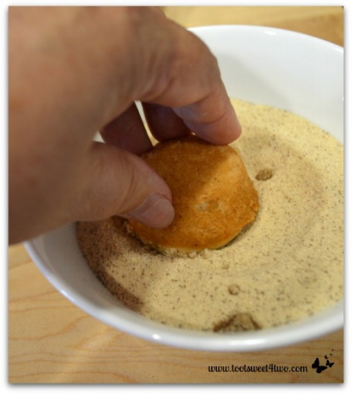 Adding cinnamon sugar to the tops of the mini-muffins