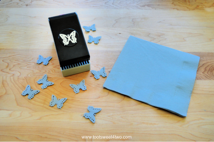 butterfly crafting punch and a blue paper napkin
