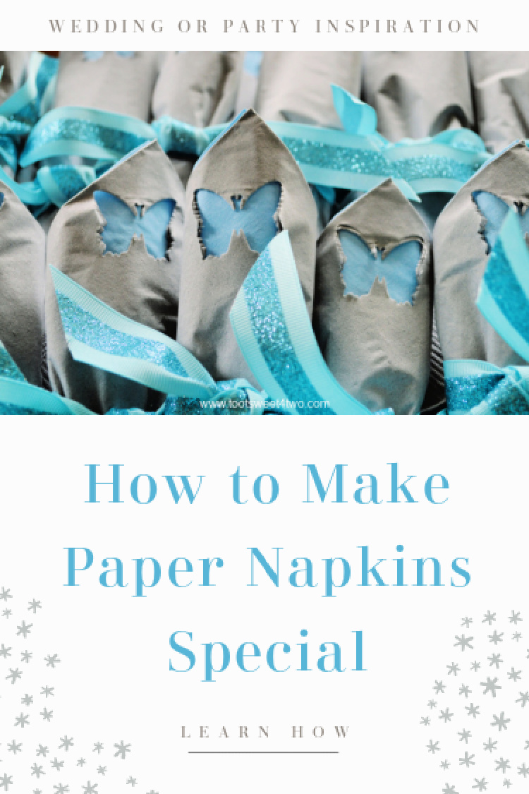 close-up of gray napkins with blue butterflies tied with blue ribbon