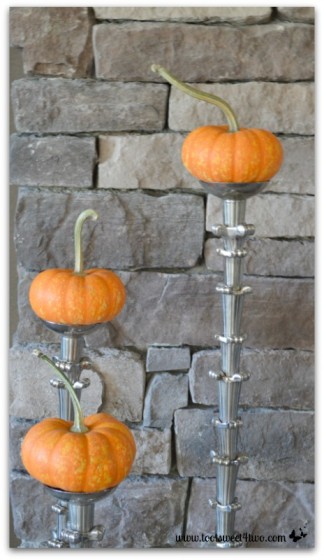 Mini pumpkins on candlesticks