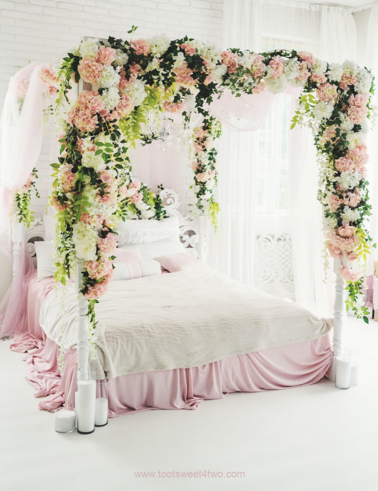 Pink and White Canopy Bed with Flower Garlands