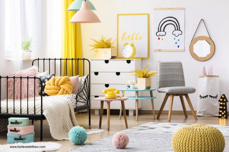 Yellow pouf and grey chair in colorful child's bedroom interior with poster on the wall