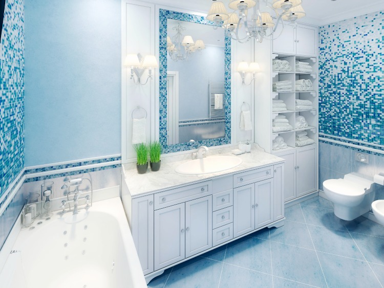 beautiful blue-tiled master bathroom with white cabinets
