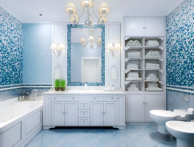 front view of beautiful blue-tiled master bathroom with white cabinets