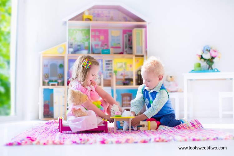 two children playing with a dollhouse