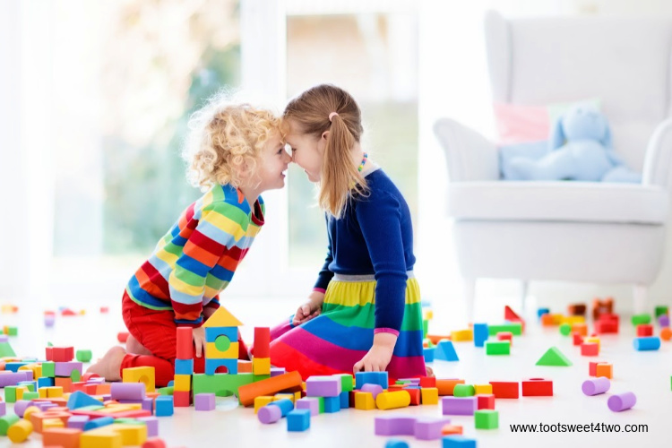 two children playing with blocks