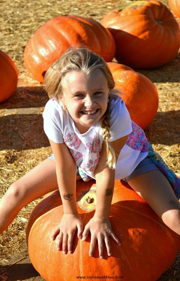 Princess P straddling a Big Mac pumpkin 2015