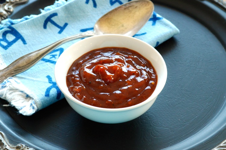 barbecue sauce in a small white bowl with a blue Western napkin