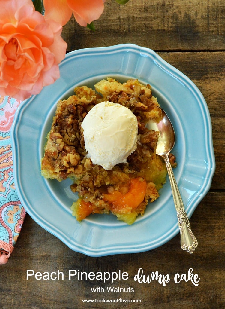 Peach Pineapple Dump Cake on a blue plate with peach roses in the corner