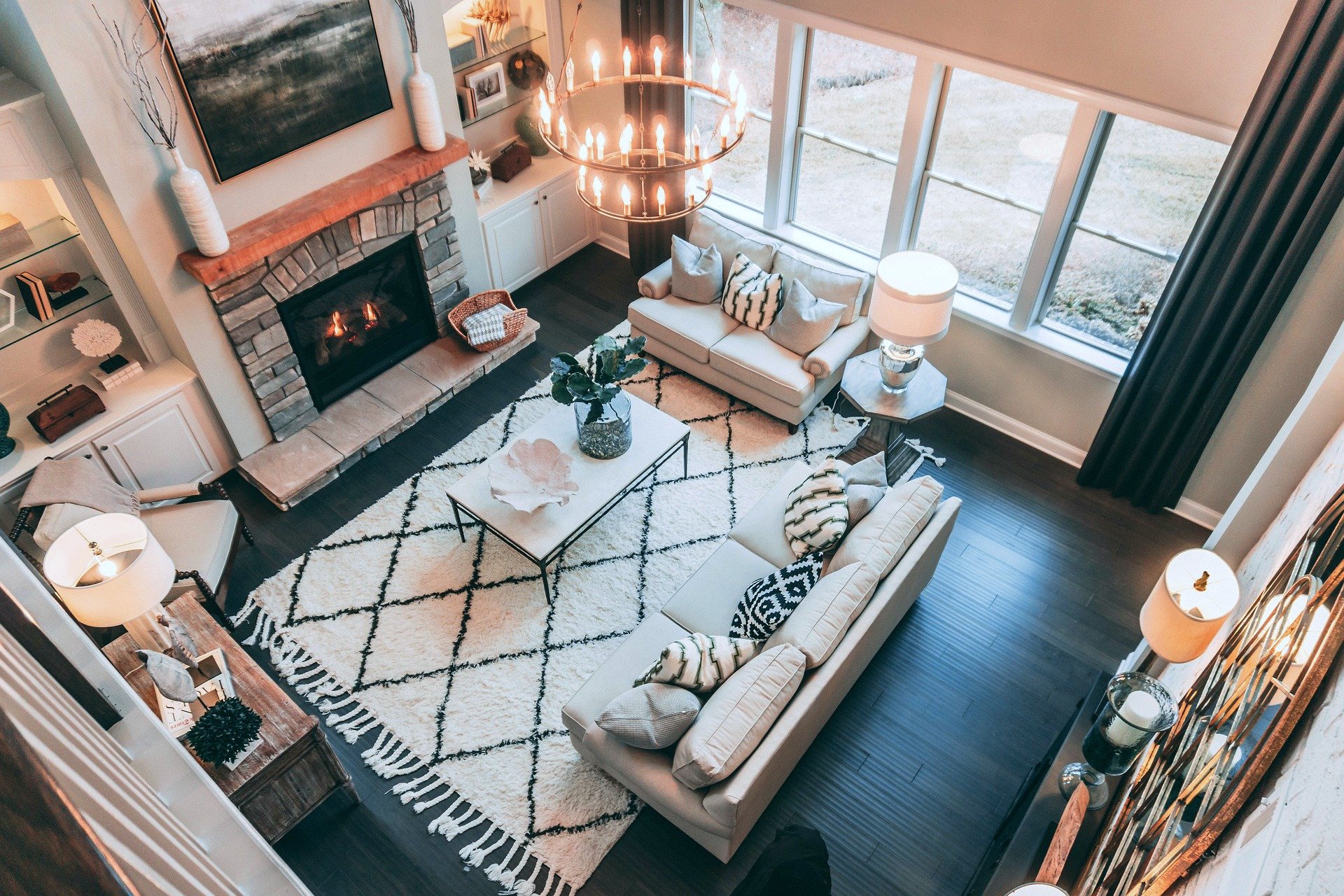 Top view of living room with large rug and beautiful fireplace