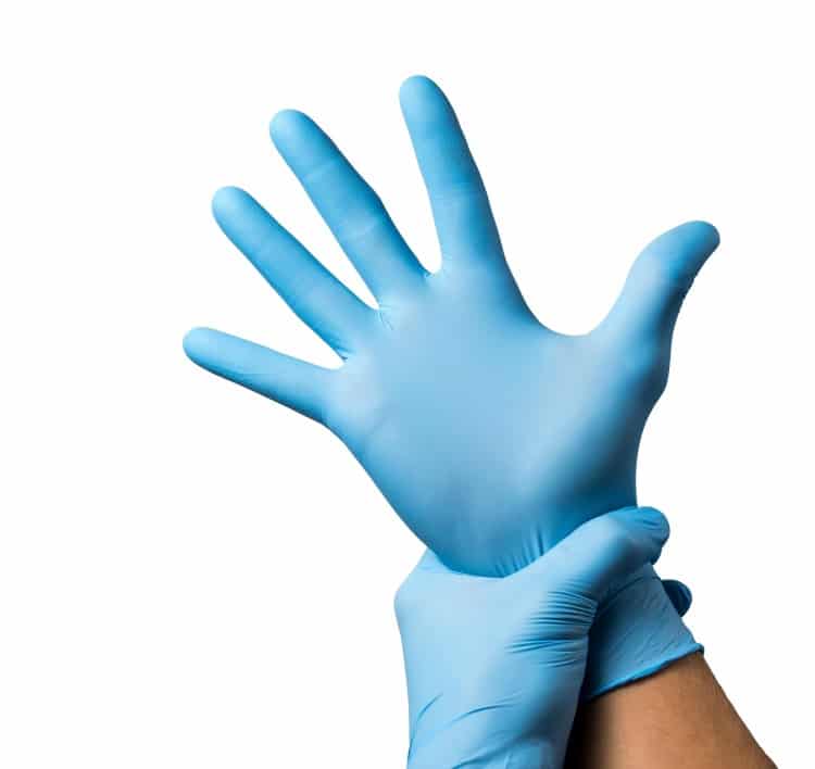 Doctor putting on protective gloves, isolated on white background