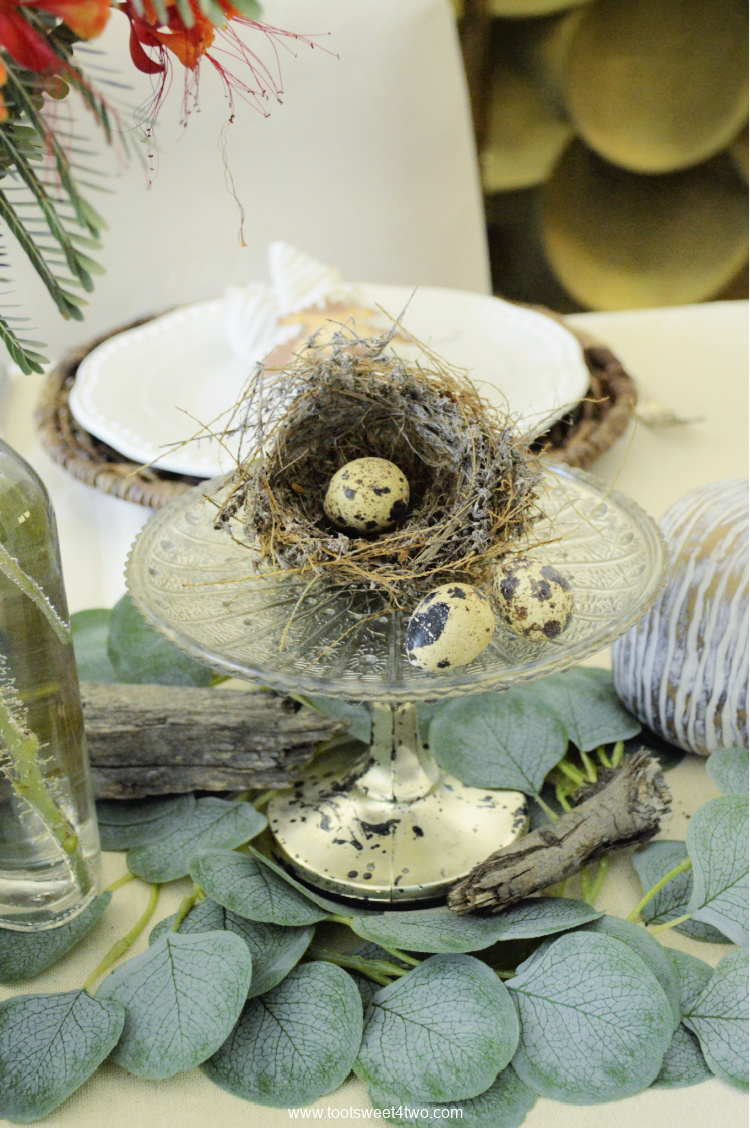 Bird's nest on silver cake stand on table