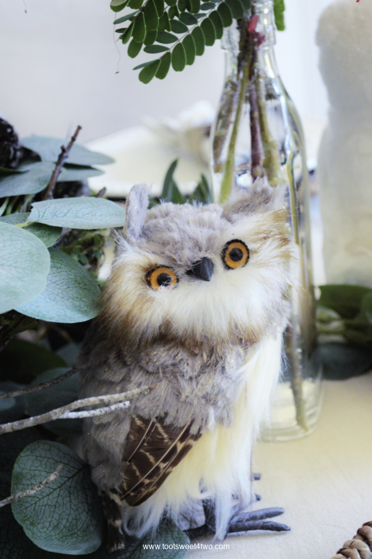 Tiny gray and white stuffed owl on table