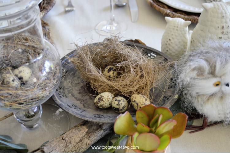 little bird's nest on a tarnished silver dessert stand