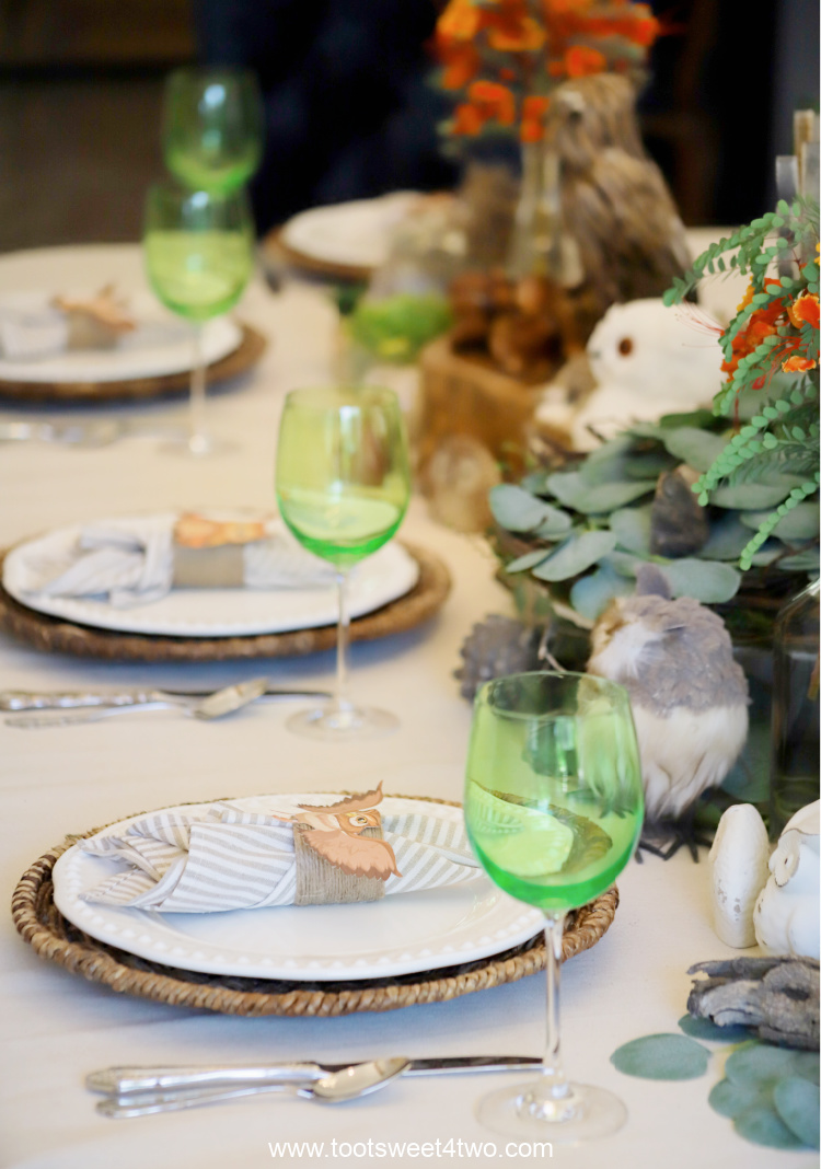 place settings on dining table with green goblets