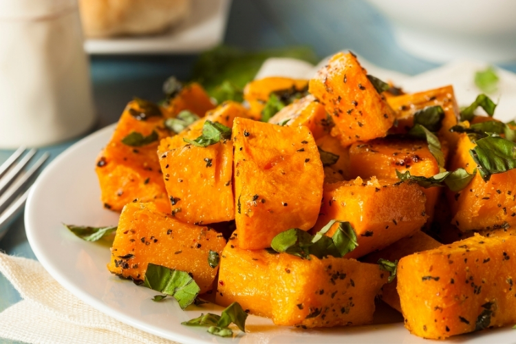 Plate of chopped up butternut squash with cilantro in a post about Instant Pot recipes.